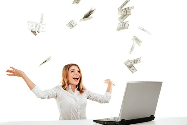 Woman with laptop and cash